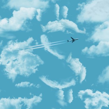 Hava seyahat maliyeti ile contrail bir mavi gökyüzünde bir dolar işareti ve bir jet uçak şeklinde bulutlar ile gösterilmektedir. Bu bir örnektir.