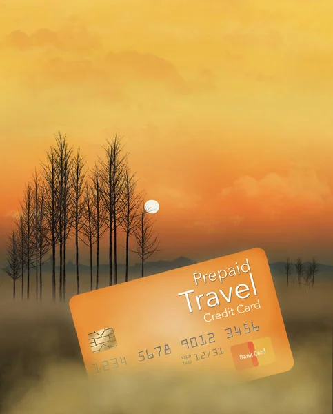 A prepaid travel credit card is seen in a meadow at sunrise with trees, fog, sky and clouds. This is an illustration