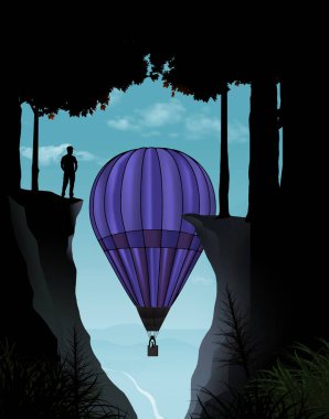 Sıcak hava balonu manzarasına yükselirken bir adam vadiye bakan yüksek bir uçurumda duruyor..