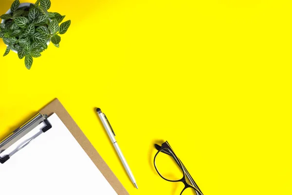 Creative workspace desk with stationery supplies on yellow background. Bright colors. Flat lay. Top view. Copy space for your design.