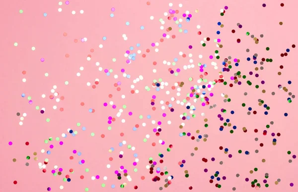 Festive pastel pink background with metallic confetti. — Stock Photo, Image