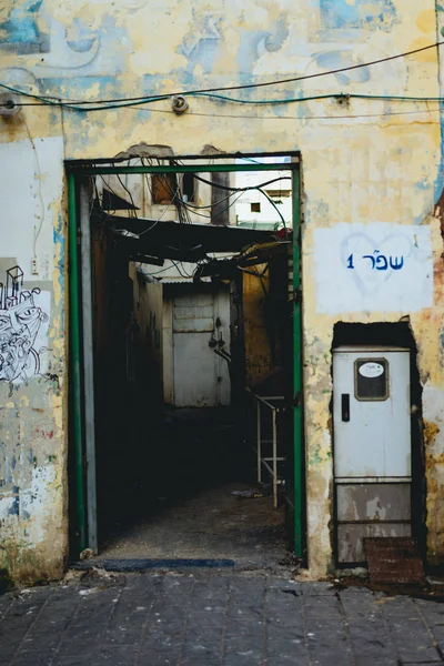 Industrial door way with a falling apart room behind it.