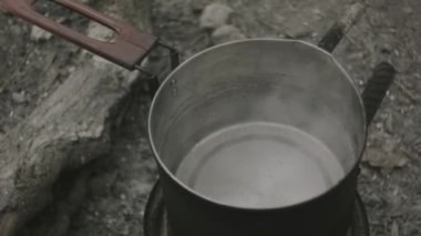 Bir tencere ateşte, su kaynıyor.