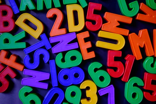 Colorful magnetic numbers and letters on the fridge