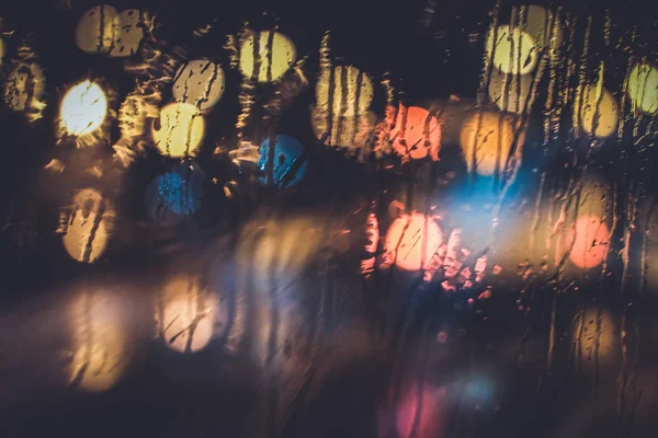 Traffic lights through the window in a rainy night — Stock Photo, Image