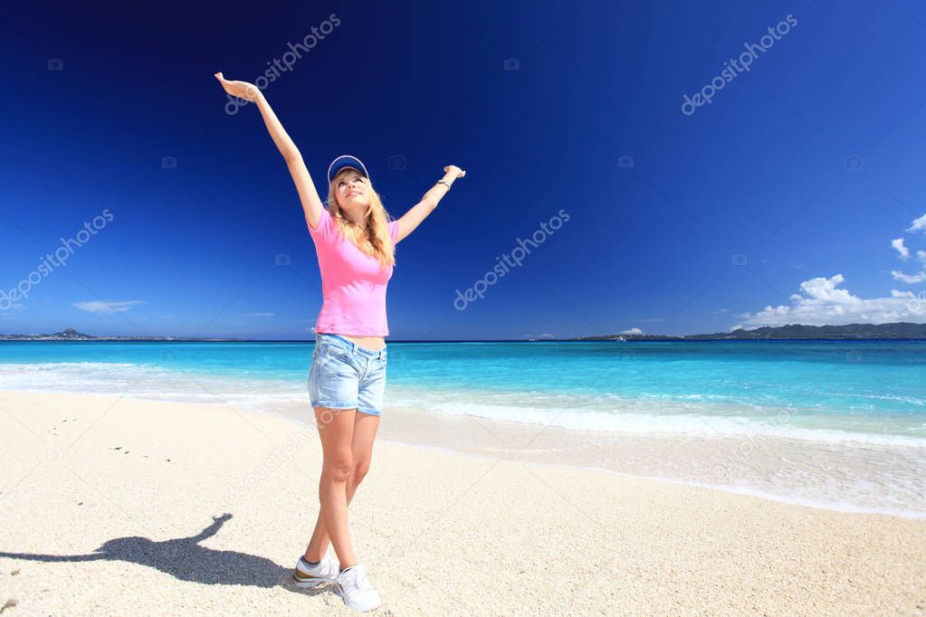 Young woman on the beach enjoy sunlight 