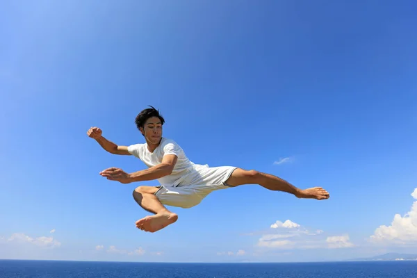 Happy man jump on beach
