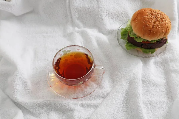 Smakelijke Hamburger Met Een Kopje Thee — Stockfoto