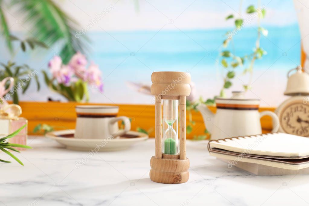 Classic wooden hourglass on the table