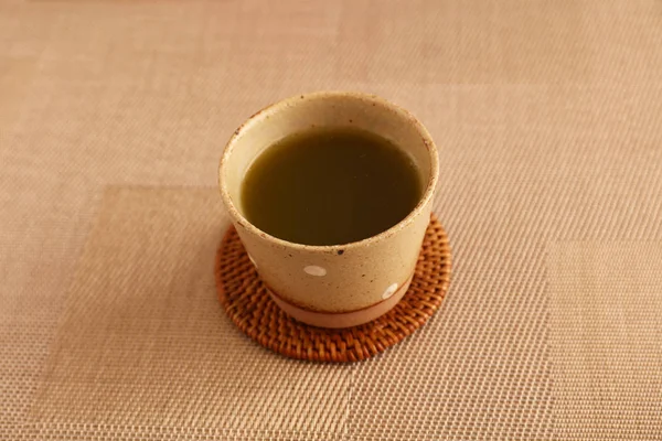 A cup of Japanese green tea on the dining table