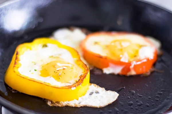 Close view of fried eggs in pepper slices