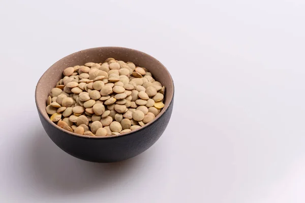 Angle View Dry Uncooked Lentils Black Ceramic Bowl Isolated White — Stock Photo, Image