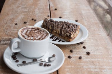 Coffee cup and chocolate pie coffee bean wooden table 