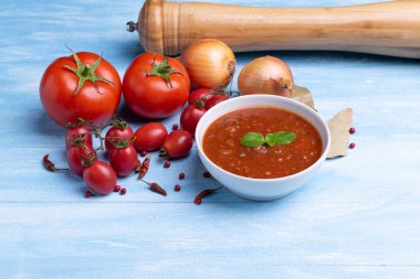 Rustik ahşap mavi masa arka plan üzerinde beyaz bir tabak domates sosu ile Bolonya