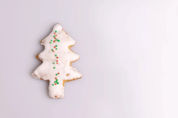 Christmas Ginger and Honey cookie. Gingerbread cookie in tree shape isolated on white background