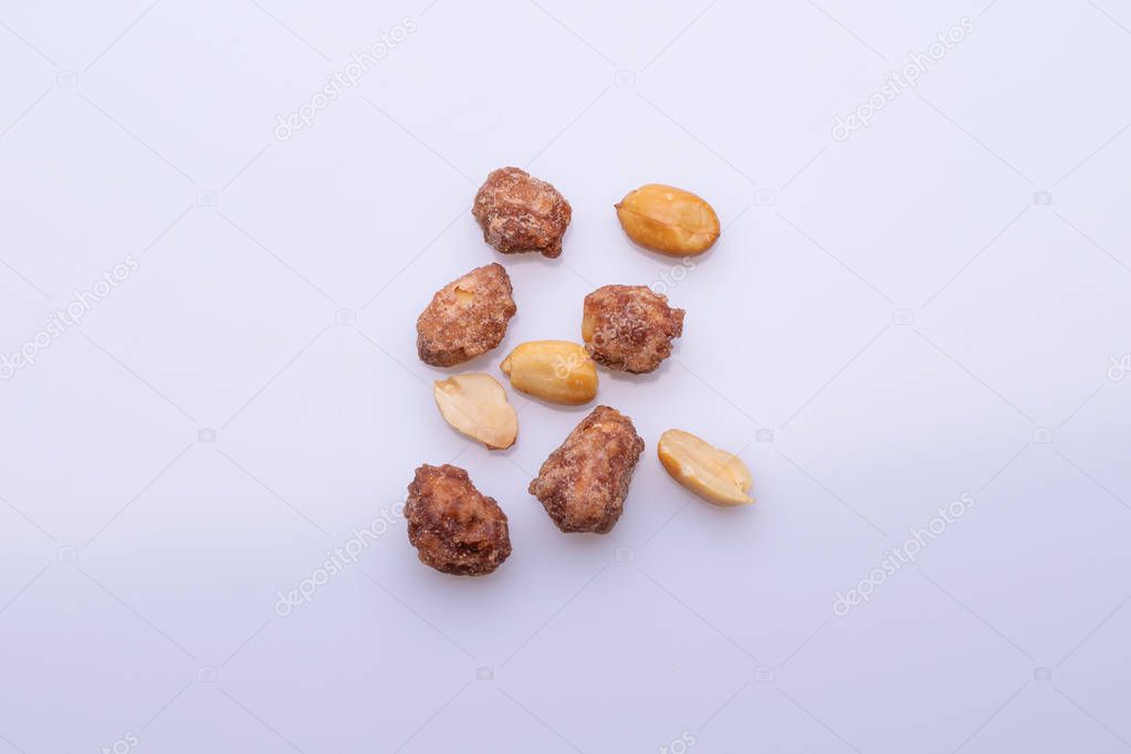 Top view of heap of peanuts praline sweet, on white background
