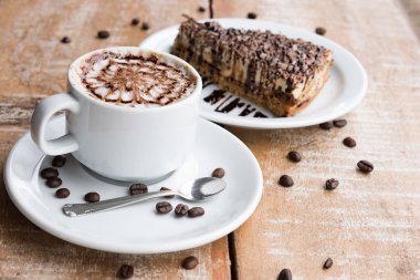 Coffee cup and chocolate pie coffee bean wooden table 