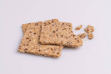 Beyaz arka plan üzerinde izole diyet keten tohumu kepekli kraker yığın yığını