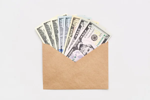 US dollars in cash in envelope on white minimal background Money concept