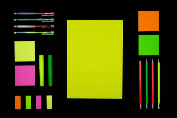 Neon paper and stationery on black — Stock Photo, Image