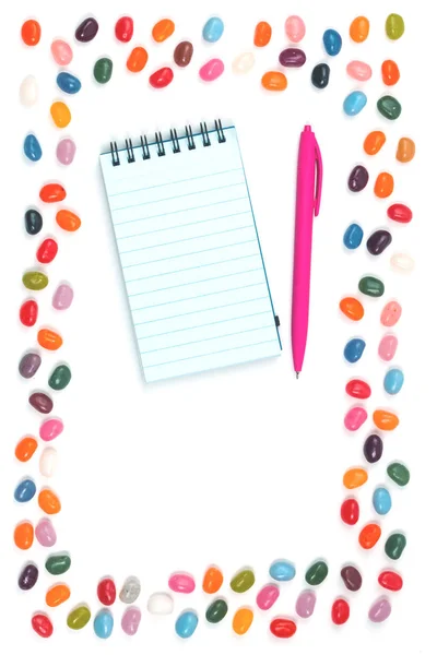 Jelly Bean Sweets Frame Notepad Pink Pen White Background Isolated — Stock Photo, Image