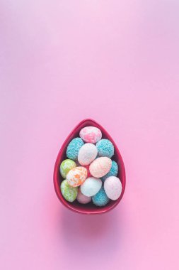 Mutlu Paskalya tebrik kartı küçük yumurta bir yumurta ile düz lay uzayda kopya ile pembe arka plan üzerinde kase şeklinde