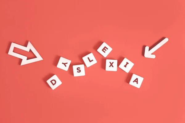Dyslexia Word Arrows Living Coral Background Reading Difficulty Disorder Concept — Stock Photo, Image