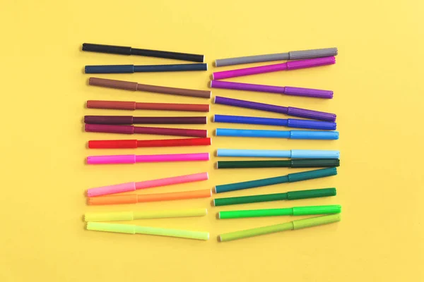 Colored rainbow gradient markers rows on yellow — Stock Photo, Image