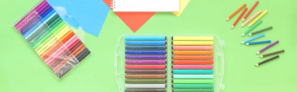 Assorted office and school stationery flat lay on green — Stock Photo, Image