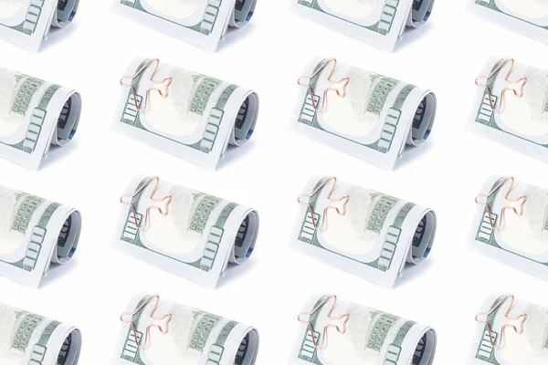 Dollars with airplane paper clip pattern — Stock Photo, Image