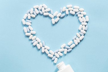 White and blue tablets pills forming heart shape clipart
