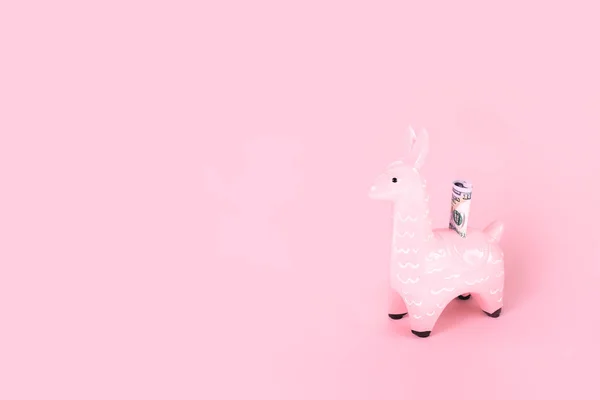 Pink toy llama money bank on monochromatic background — Stock Photo, Image