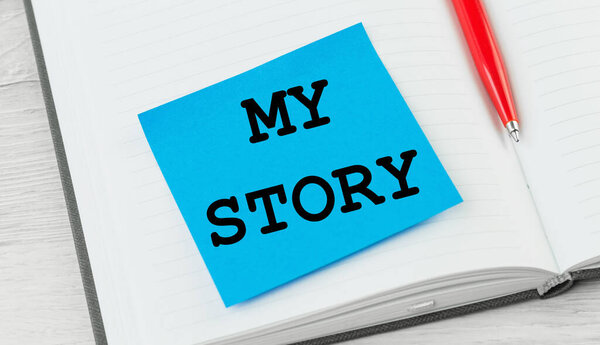 My story text on blue notice paper on notepad or diary. Storytelling concept or presentation