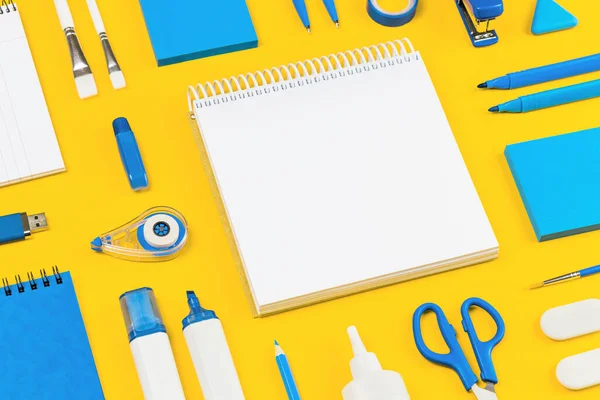 Blue and white assorted office and school supplies stationery on yellow flat lay. Organized knolling for back to school or education and craft concept. Selective focus. Copy space. Template or mockup