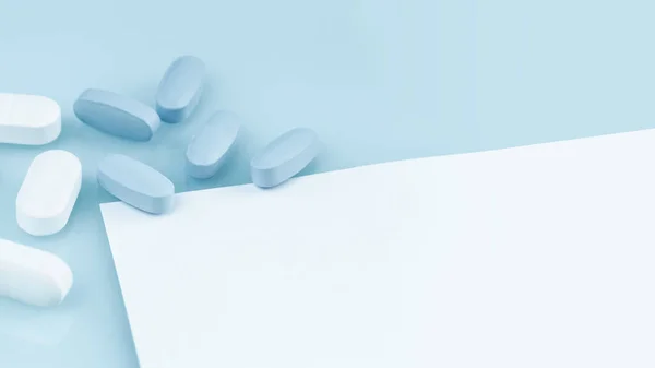 Medical banner. many white and blue capsule tablets or pills on the table. Close up notice copy space. Healthcare pharmacy and medicine concept. Painkillers or prescription drugs consumption