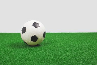 Yeşil sahada futbol topu. Futbol maçı ya da okul konsepti. Boşluk afişini kopyala