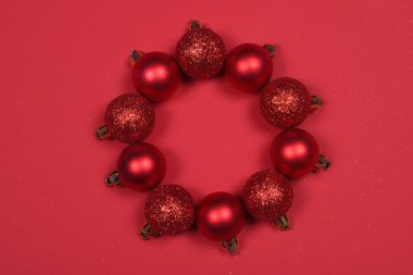 Kırmızı kırmızı zemin üzerine bir Noel çelenk şekillendirme Baubles.