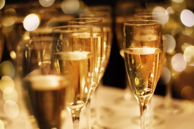 Champaign bir masada çok görünür kabarcıklar ile gözlük ile Festival ışıkların arka plan bulanık. Kutlama kavramı.