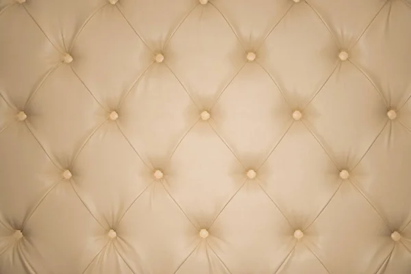 Genuine luxury leather upholstery beige background with vigniette. Copy space for text. Design and fashion concept.