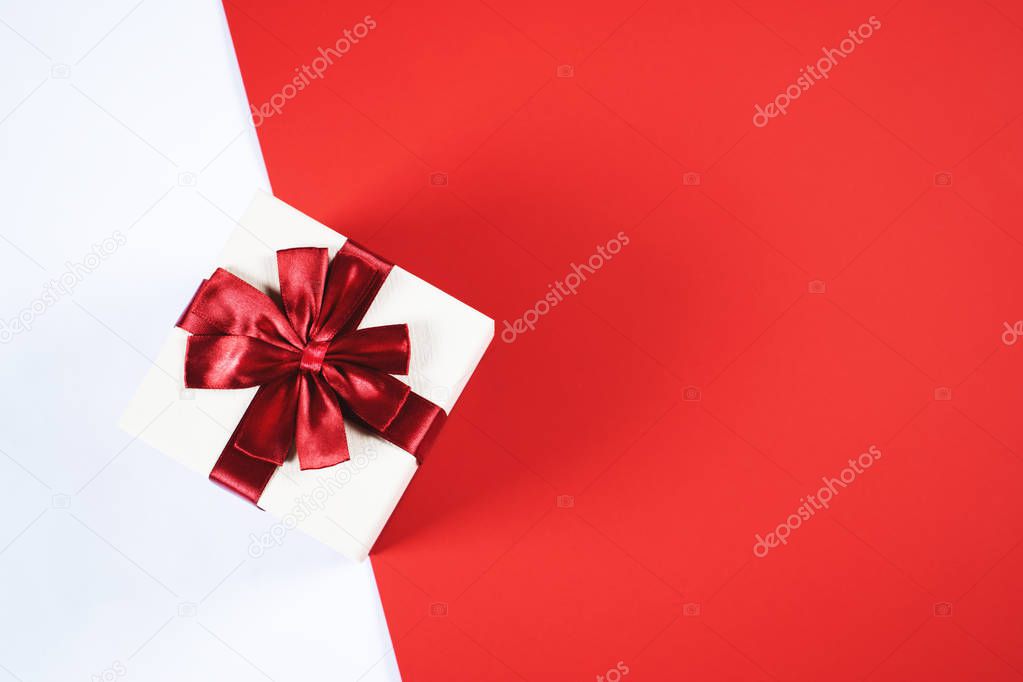 Beautiful present box on red and white background.