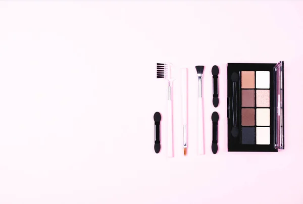 Make-up woman essentials on pink. — Stock Photo, Image