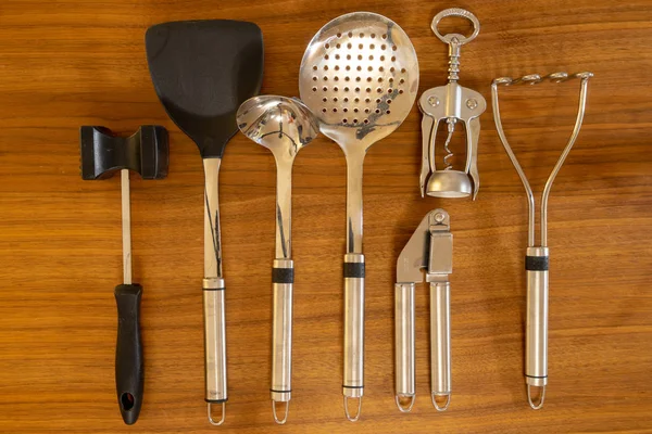 Set of kitchen tools with top view on wooden background