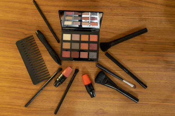 A set of cosmetics including eye shadows, lips and hair tools