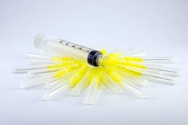 endodontic syringe for flushing the root canals of the tooth. Close-up of macro tools for dental treatment clipart