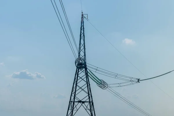 power line close-up on a blue sky background using toning. Energ