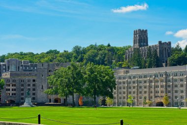 WEST POINT, NY - SEPTEMBER 4, 2018: The Cadet Chapel rises above the MacArthur Barracks and the Plain, with the George Washington statue at left, at the United States Military Academy. clipart