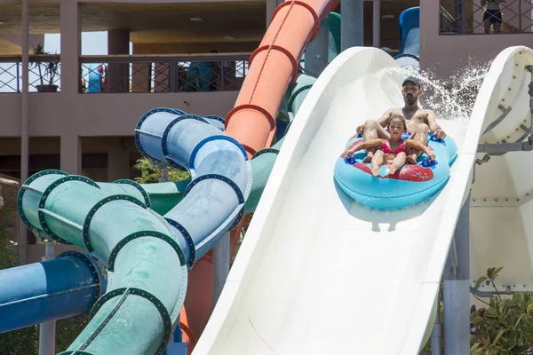 In the summer, on a bright sunny day, in a water park, father an — Stock Photo, Image