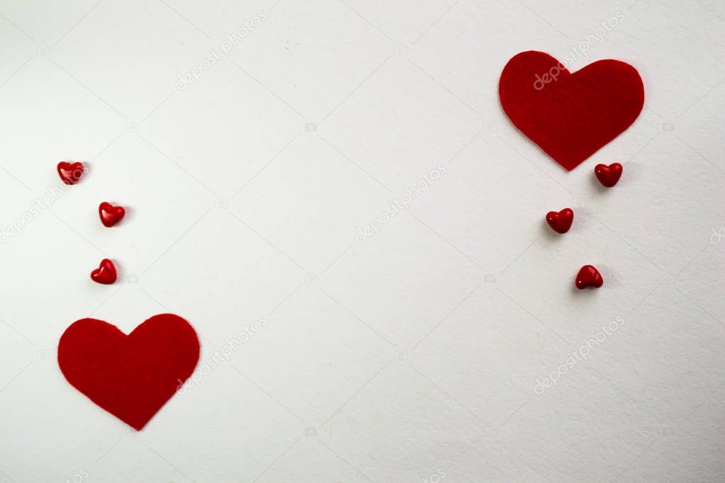 Top view with space for your greeting. White background red small hearts. Valentine's day decoration with copy space