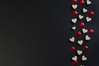 Valentines day background with red hearts on black table, top view. Wood heart for valentine concept clipart