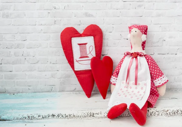 Textile doll-housewife. With handmade textile hearts. Handmade. Holidays decoration. Interior fairy dolls. Women friendship.